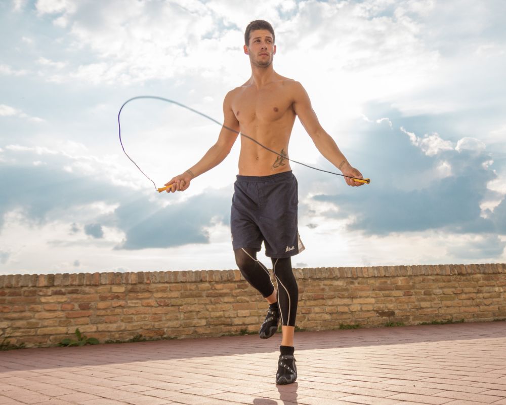 man exercising with jumping rope