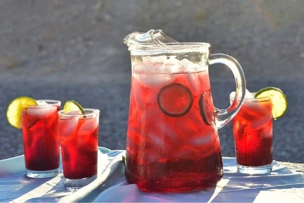 cold brewed hibiscus tea in a pitcher and glasses