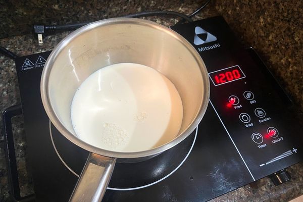 heating milk on a stove